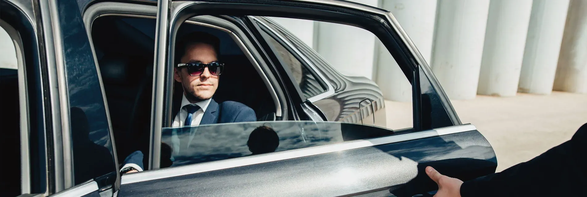 Man in a car travelling to a meeting