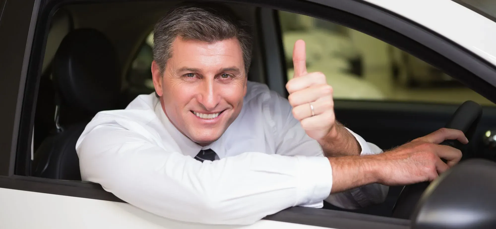 A Fleet Minicab Driver With thumb up